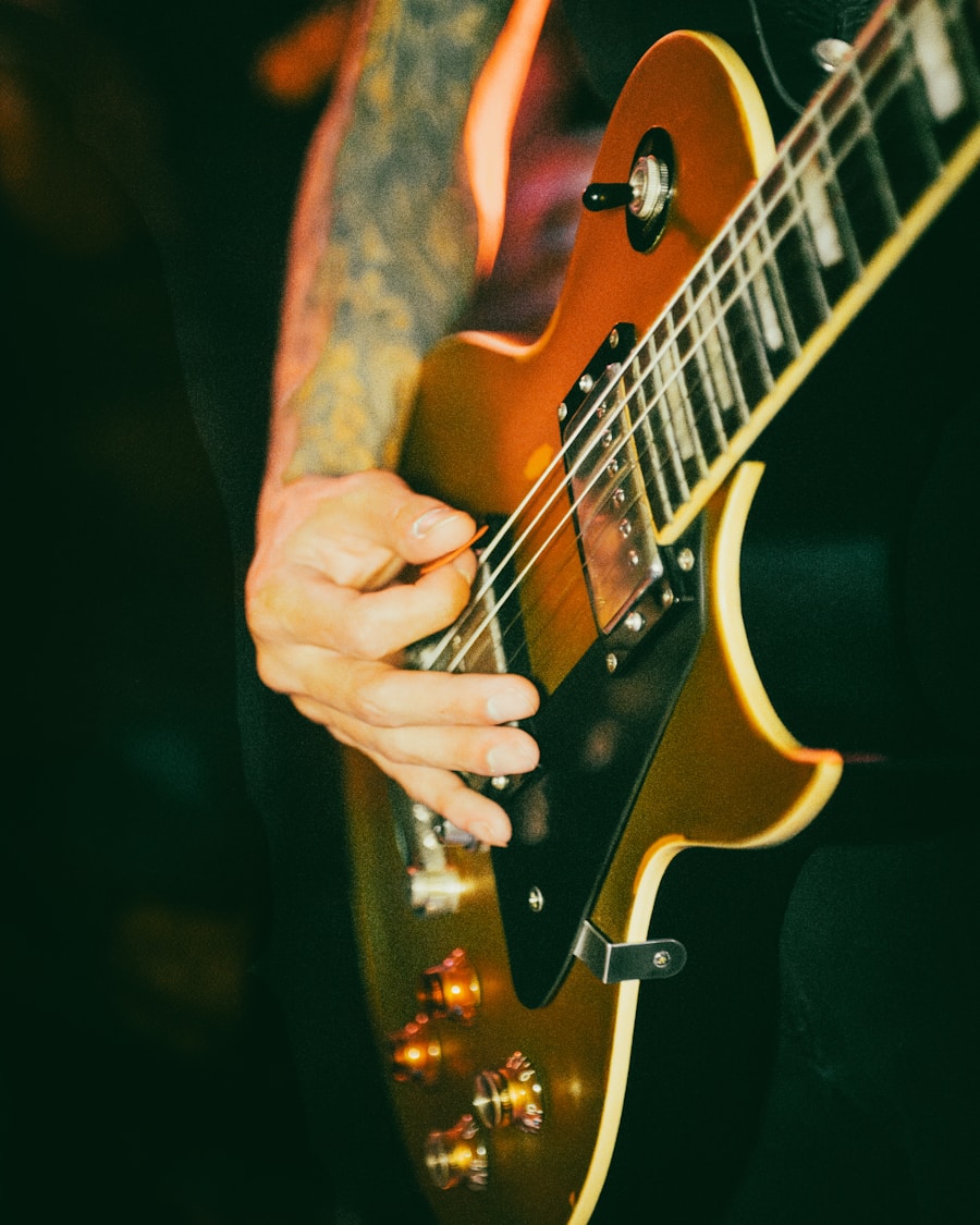 Close-up of a musician playing a sunburst electric guitar