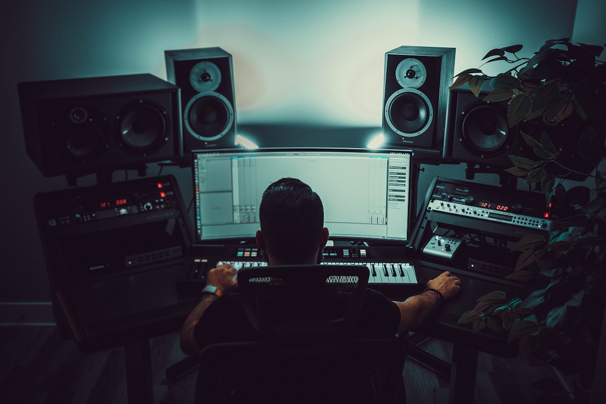 A music production workspace with studio monitors and a recording console